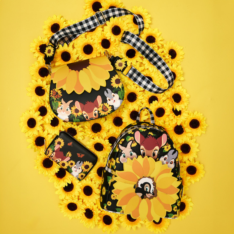 Bambi Sunflower Friends Mini Backpack, Crossbody Bag, and Wallet featuring Bambi, Thumper, Miss Bunny, and Flower surrounded by sunflowers and butterflies. The three lay against a yellow background surrounded by sunflowers. 